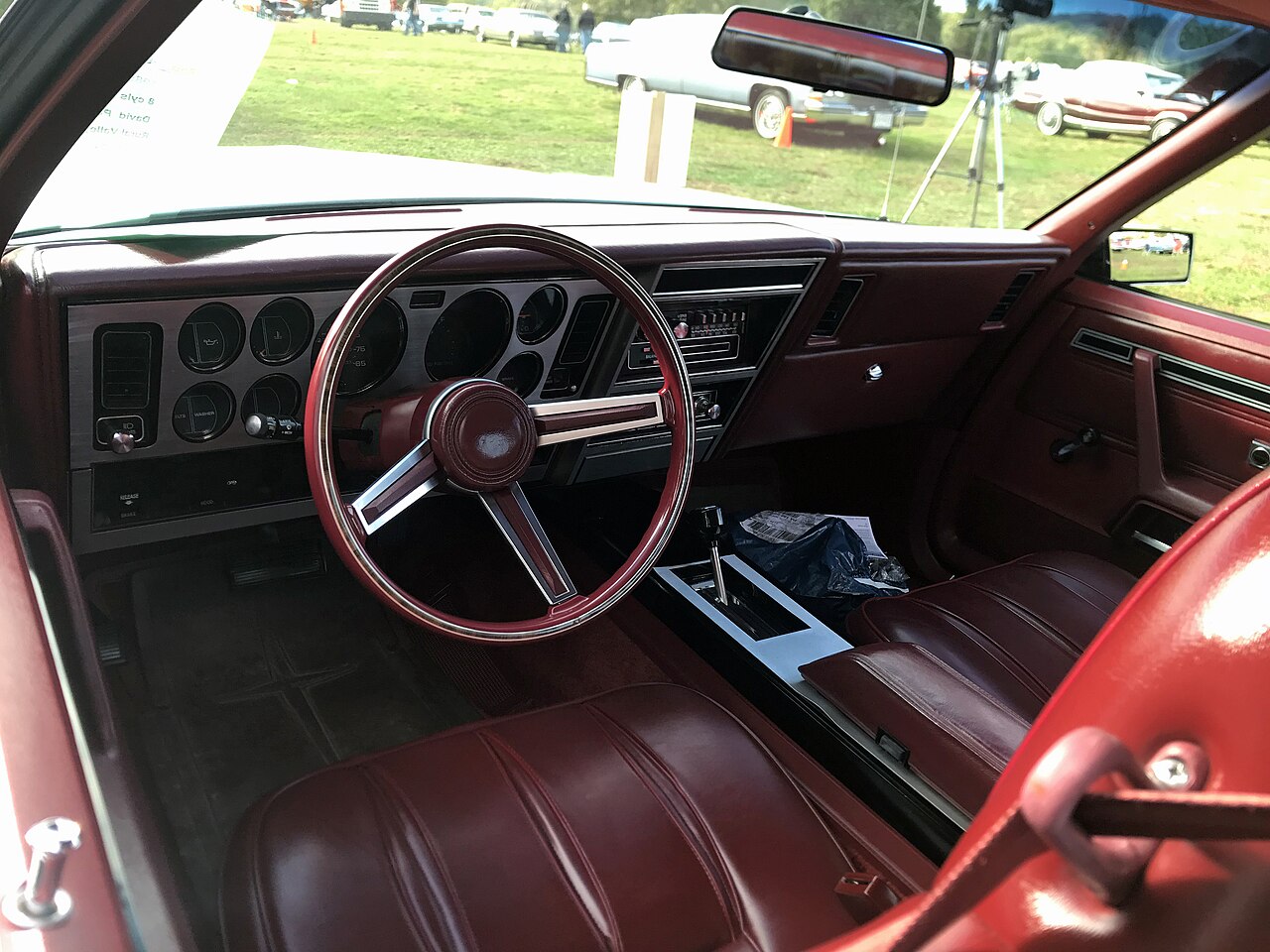 Dodge Mirada 1980 - deska rozdzielcza i kierownica Dodge Mirada rocznik 1980 - czerwona deska rozdzielcza, kolumna kierownicy i obszar kierowcy pomocny w lokalizacji skrzynki bezpieczników